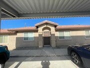Front entry and covered parking - 73641 Sunnyslope Dr Apartments