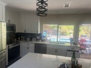 shared kitchen in the house with pool/hot tub in background - 7073 Mewall Dr House
