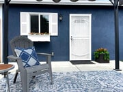 Sitting area with new rug under retractable pergola for shaded comfort - 3541 Helms Ave House