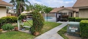Serene sitting bench and entrance to swimming pool at Las Casitas Apartments in Riverside, California. - Las Casitas Apartments