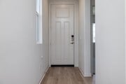 Bright and welcoming entryway with laminate flooring and modern white door, creating a clean - 26549 Brightstone Dr