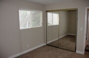 2nd bedroom_mirror closet door_palm tree visible - 227 La Paloma Unit A