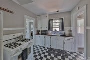 Kitchen connects dining to back yard - 1530 E 5th St House