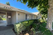 Mature trees and gardens near front entrance to Eucalyptus Apartments in Moreno Valley, California. - Eucalyptus Apartments