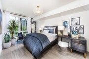Spacious bedroom with refined finishes and oversized windows framing greenery. - 580 Anton