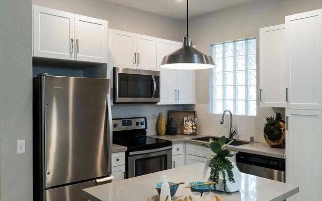Modern Kitchen with Stainless Steel Appliances and White Cabinetry - Amerige Pointe