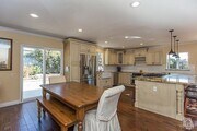 Photo - Located on a tree-lined street is this met... House