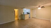 View of the front door, kitchen, and door to the bedroom and bathroom - 7777 W 91st St Condo Unit B1153
