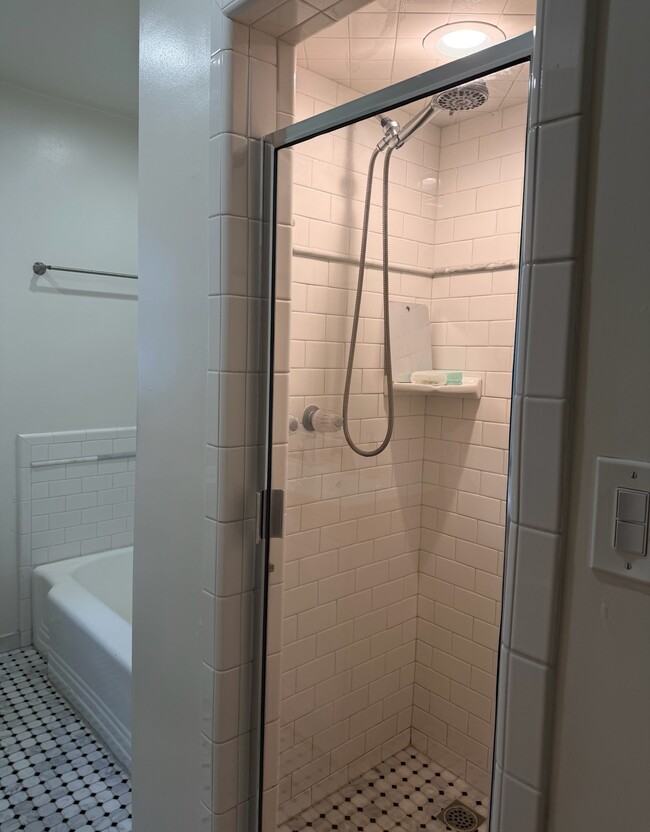Separate shower and tub with beautiful subway tile - 9933 Robbins Dr Unit 10