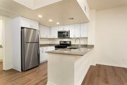 Renovated Package I kitchen and dining area with hard surface flooring - eaves Thousand Oaks Apartments