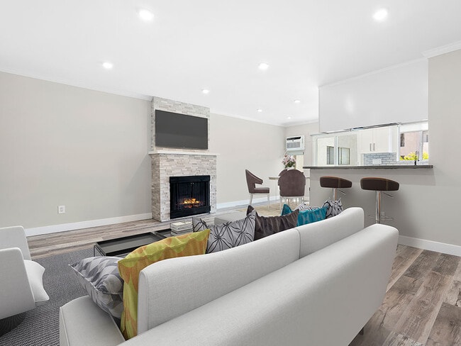 Hardwood floored living room with stone accented fireplace. - 1249 South Bundy