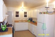 Kitchen with the old butcher block countertops (now quartz) and old appliances (now stainless steel) - 24606 University Ave Townhome