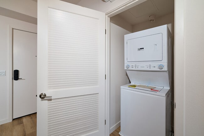 Enjoy the ultimate everyday convenience of a modern in-unit stacked washer and dryer. - textur Apartments