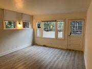Living room facing front door and front window. - 24606 University Ave Townhome