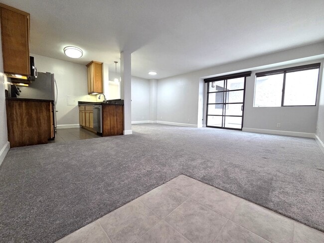 Living and dining area. Door to outside balcony. - 10982 Roebling Ave Unit 464