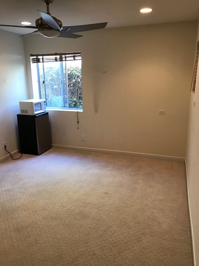 Bedroom with fridge & microwave. - 133 43rd St Unit BeachStudio