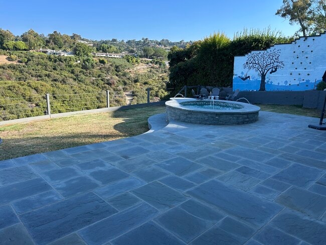 Backyard bluestone, in ground fountain/jacuzzi and rock climbing wall. - 27078 Sunnyridge Rd