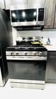 New kitchen With stainless steel refrigerator, dishwasher, microwave, and stove. Garbage disposal - 6600 Warner Ave Unit Modern Condo