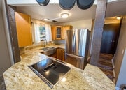 Kitchen with stainless steel electric range, barn style sink and refrigerator - 1097 Club View Dr House Unit C