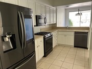 Kitchen to backyard view - 10924 Creekbridge Plz Townhome
