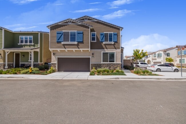 Front view of a modern two-story home with a spacious driveway, landscaped yard, and large windows o - 26549 Brightstone Dr