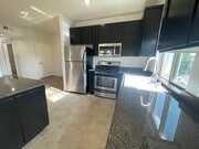 Living room and kitchen - 5842 Harold Way Apartments Unit 304