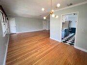 Dining area, living room on right, kitchen on left. Sputnik style brass chandelier. - 1327 N Central Ave Unit #F
