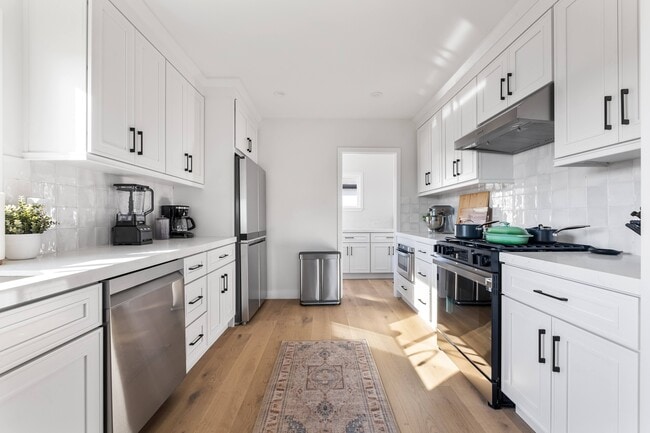 Chef's kitchen with natural sunlight and luxury appliances. - 1823 N Ditman Ave House