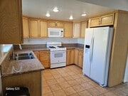 Kitchen complete with range/oven, new refrigerator, microwave, and dishwasher. - 1344 E Windsor Rd Unit A/front