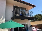 Photo - Beautiful Townhome with large fenced back patio, second story balcony, and two covered parking spots