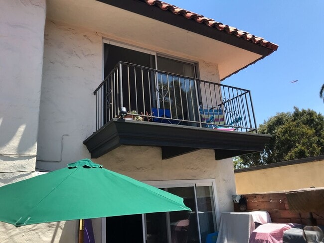 Photo - Beautiful Townhome with large fenced back patio, second story balcony, and two covered parking spots