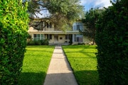 Lawn surrounded by tall hedge - 5782 Clemson St Apartments Unit 5782