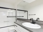 Modern styled bathroom with shower and tub. - Cedar Glen Apartments