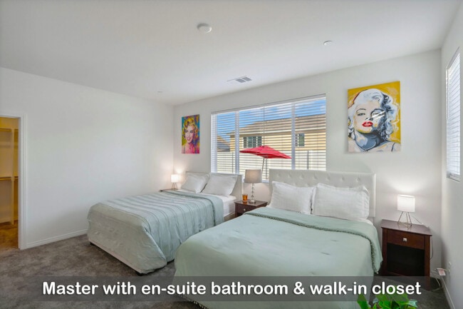 Master bedroom featuring an en-suite bathroom and a spacious walk-in closet. - 30153 Truckee Cir