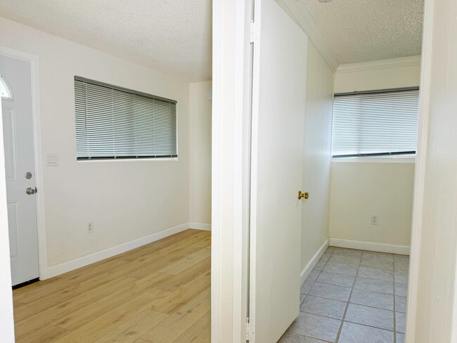 Front entry room on left, bedroom on right, standing in door to kitchen - 1722 E Victoria Ave