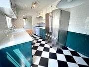 Kitchen with stainless steel refrigerator, refurbished vintage O'keefe and Merritt stove. - 1327 N Central Ave Unit #F