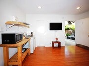 Facing TV wall, bathroom door, front door; rent includes ALL utilities - 828 7th St Apartments Unit C