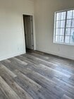 Bedroom with generous natural lighting, complete with a roomy closet. - 4043 1/2 W 21st St Unit 4043  half