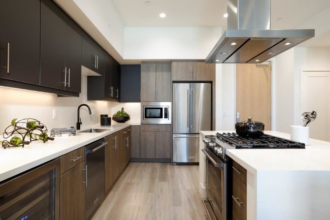 Sleek kitchen with stainless steel appliances - One Uptown Newport