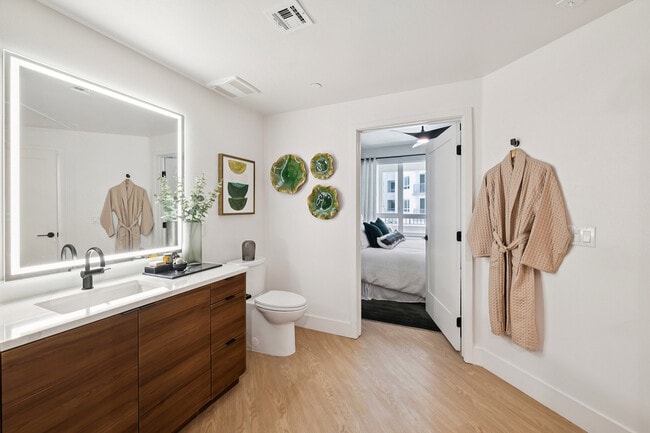 Warm wood vanity with unique bathroom layout - AMLI Aero