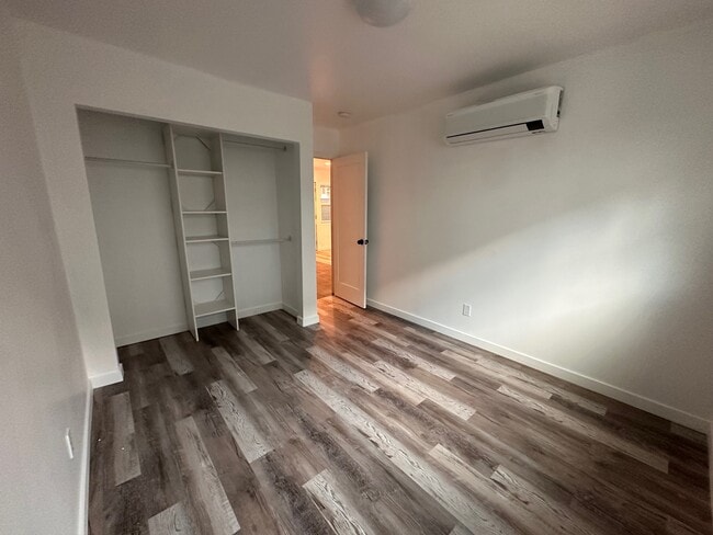 Bedroom with closet organizer and AC/heater unit - 2146 Felspar St Unit 2146