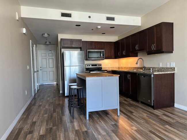 Newly Renovated Kitchen with granite countertops, stainless steel appliances, and wood floors - 427 9th Ave Condo Unit 907