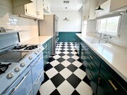 Kitchen, black and white checkerboard tile, farmhouse sink, subway tile, quartz countertops. - 1327 N Central Ave Unit #F