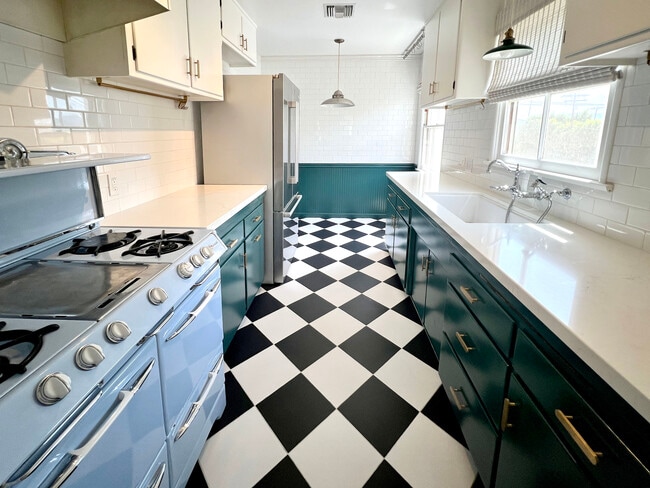 Kitchen, black and white checkerboard tile, farmhouse sink, subway tile, quartz countertops. - 1327 N Central Ave Unit #F
