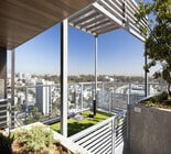 Luxurious rooftop terrace with lush green landscaping, offering panoramic city views and stylish modern design. - Ancora