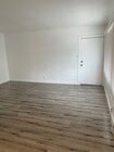 Living room w/ Entrance door - 12329 Oxnard St Apartments Unit 1