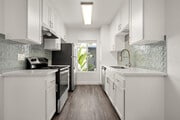 Cook, dine, and gather in a stylish kitchen space. - Palms Apartments
