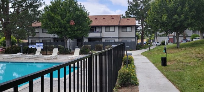 Dove Ridge scenic path by fenced pool area. - Dove Ridge Apartments