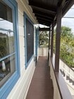 front balcony and stairs - 8252 Rees St Apartment Unit Spanish Cottage