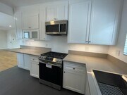 kitchen. stainless steel samsung gas range and microwave. under counter light - 7855 W Manchester Ave Unit 3